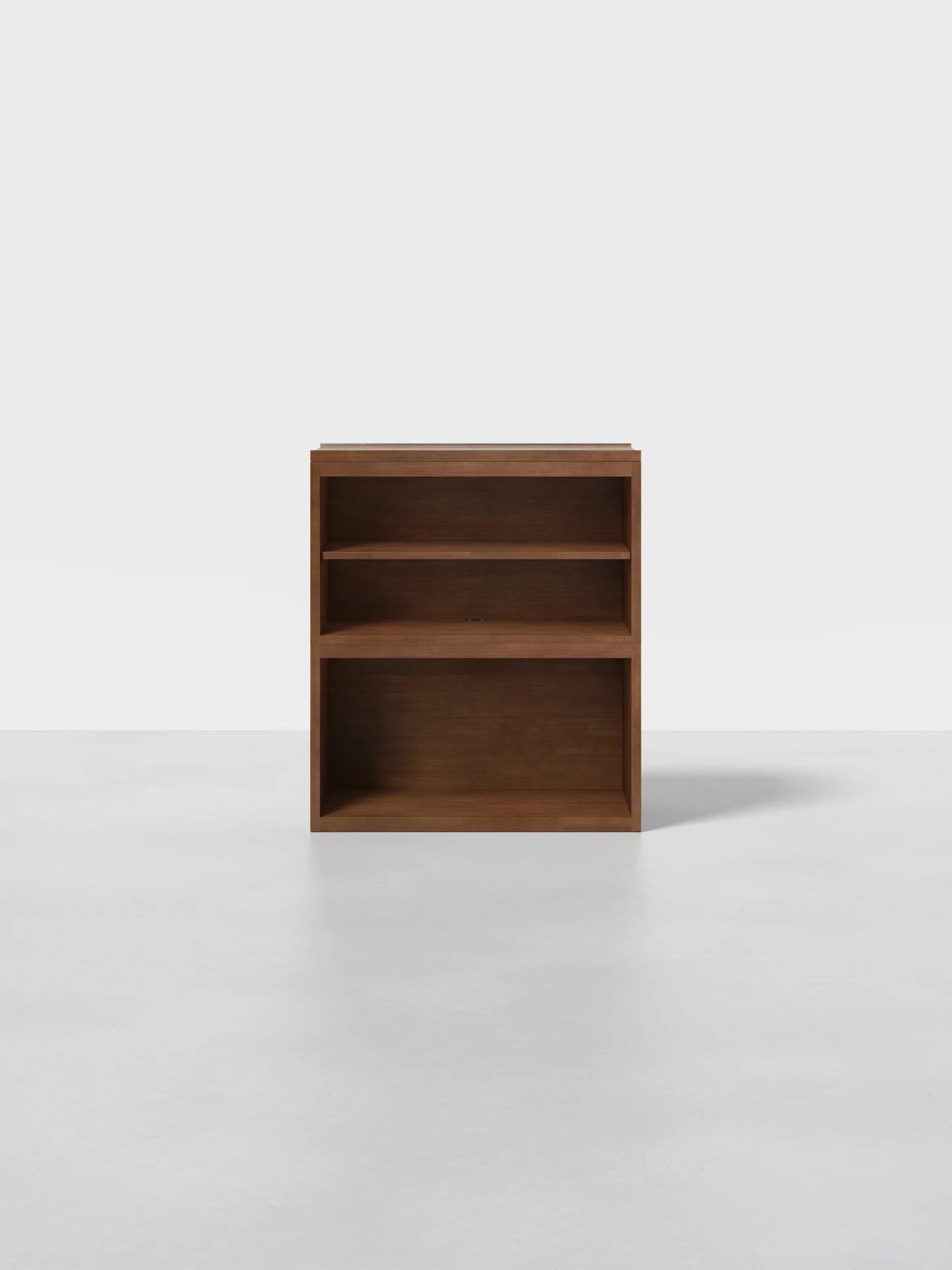 Wooden storage unit with three open shelves, placed on a light gray floor against a white background.