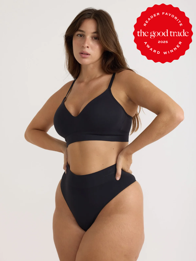 A woman wearing a black bra and high-waisted underwear stands with one hand on her hip. A red "The Good Trade 2025 Reader Favorite Award Winner" badge is in the top right corner.