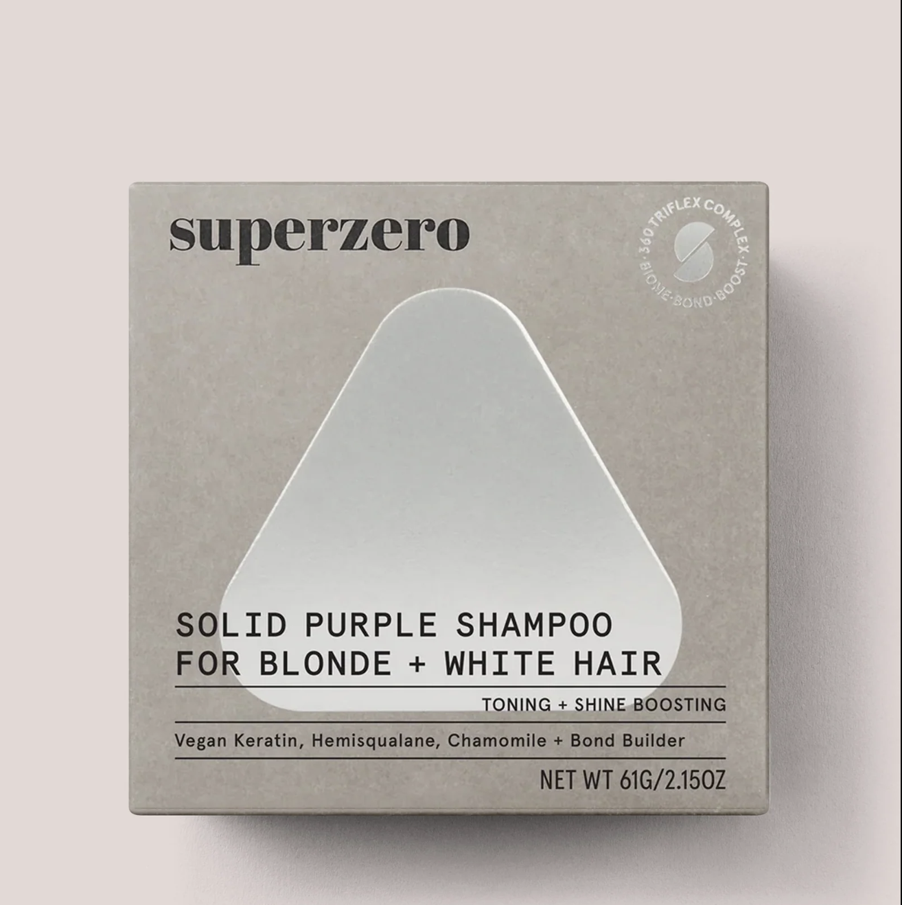 Superzero Solid Purple Shampoo box for blonde and white hair, featuring toning and shine boosting. Contains vegan keratin, hemisqualane, chamomile, and bond builder, 61g/2.15oz.
