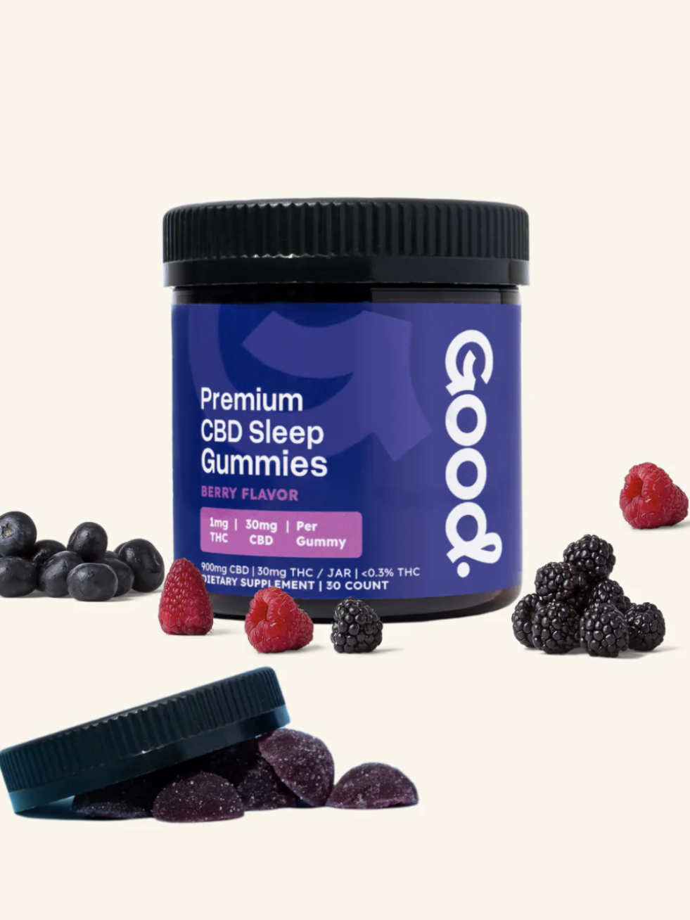 A jar labeled "Premium CBD Sleep Gummies" with berry flavor stands upright, surrounded by blackberries, blueberries, raspberries, and several gummies, with the lid resting nearby.