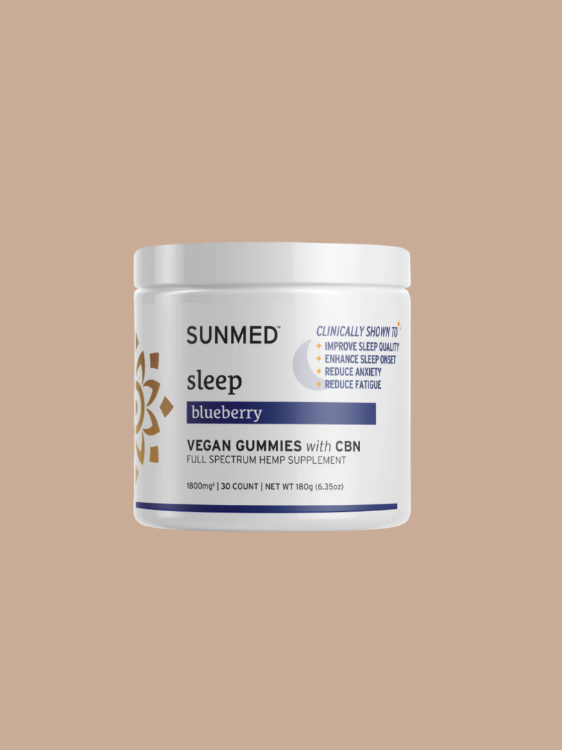 A white jar labeled "SUNMED sleep blueberry VEGAN GUMMIES with CBN" sits against a beige background. The label highlights benefits like improved sleep quality and reduced fatigue.