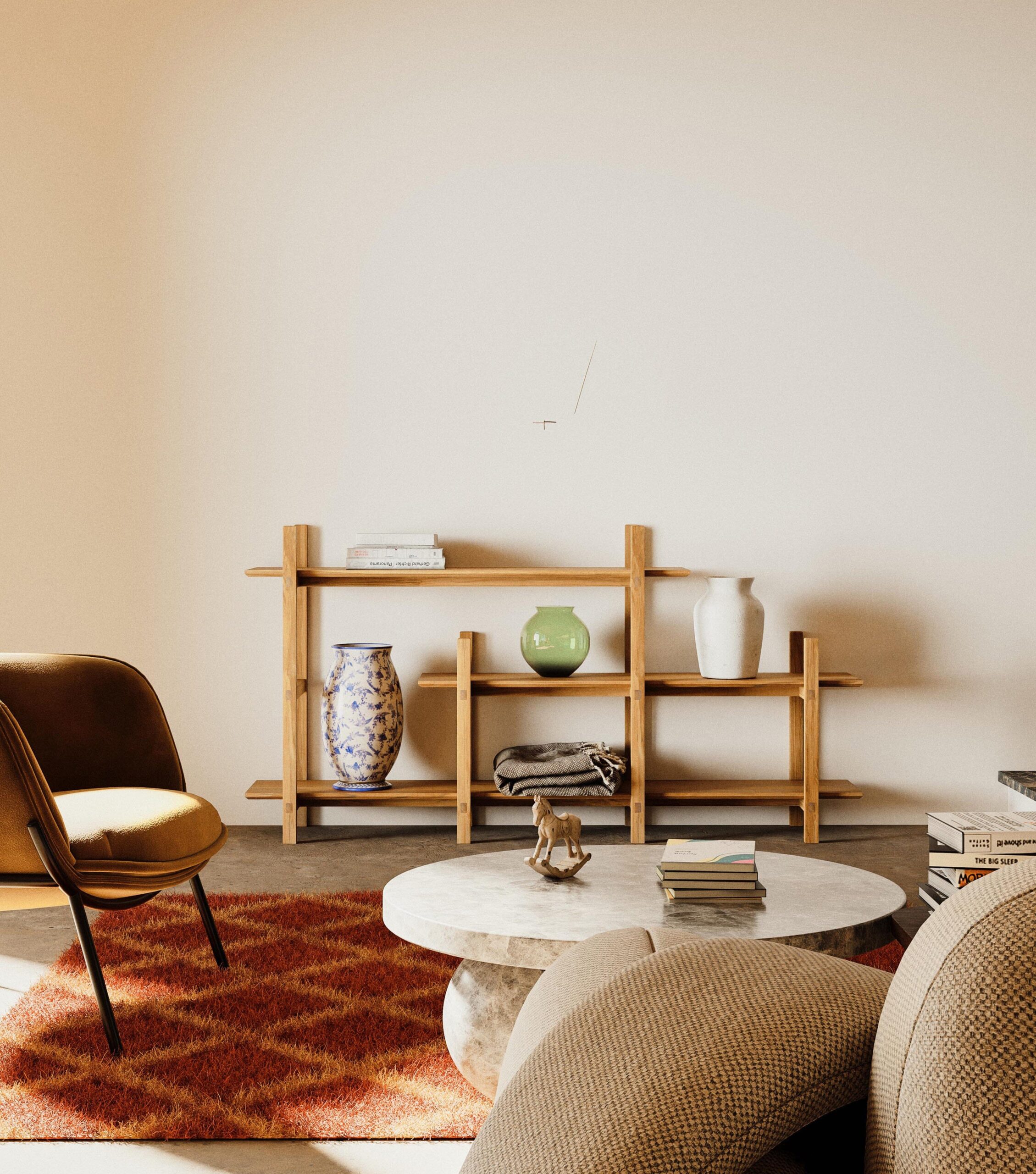 Wooden shelf with books, vases, and decor against a beige wall; tan armchair, white round coffee table, and patterned rug in foreground.