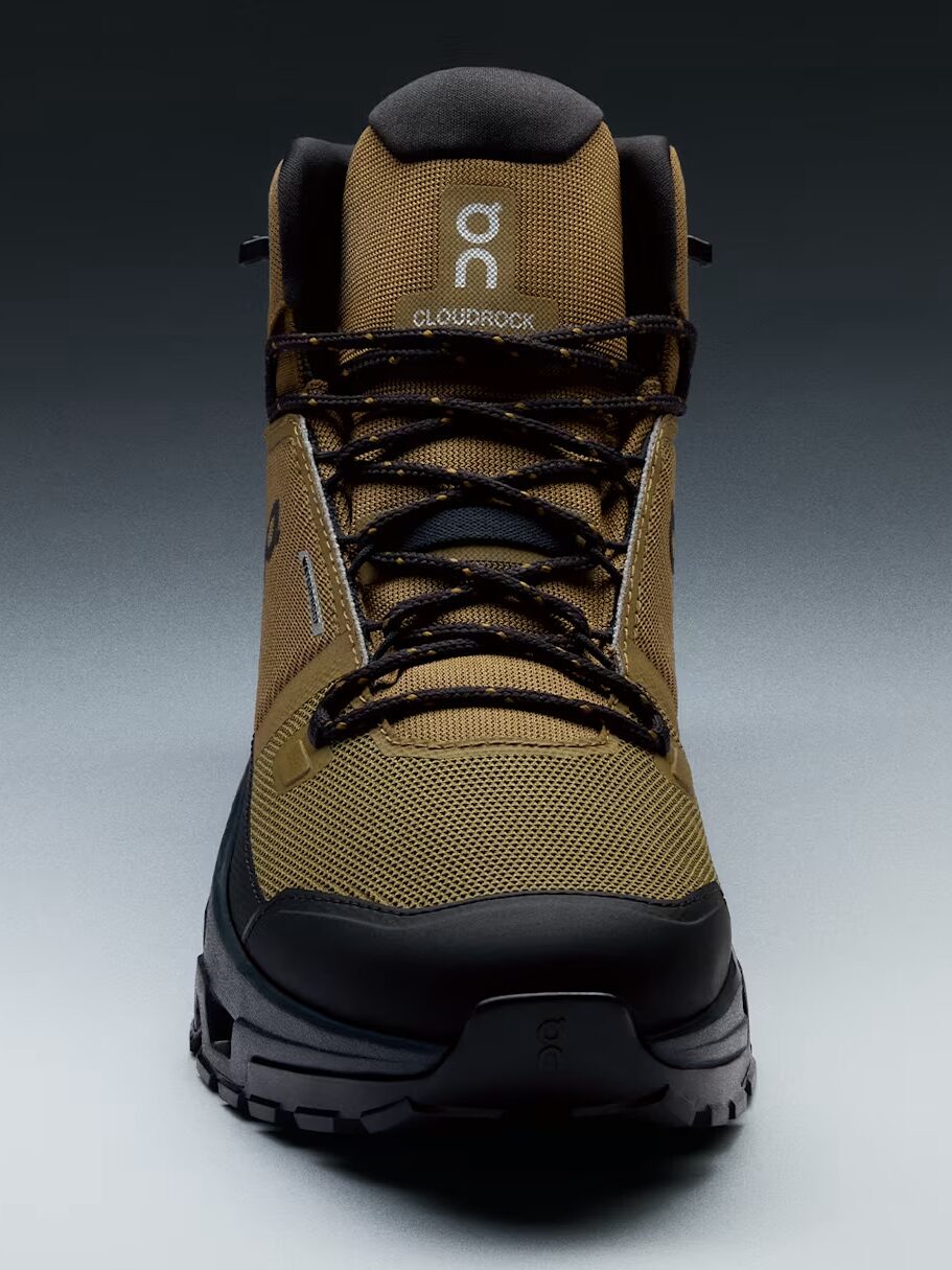 A front-facing view of a brown and black hiking boot with "Cloudrock" branding on the tongue against a neutral background.