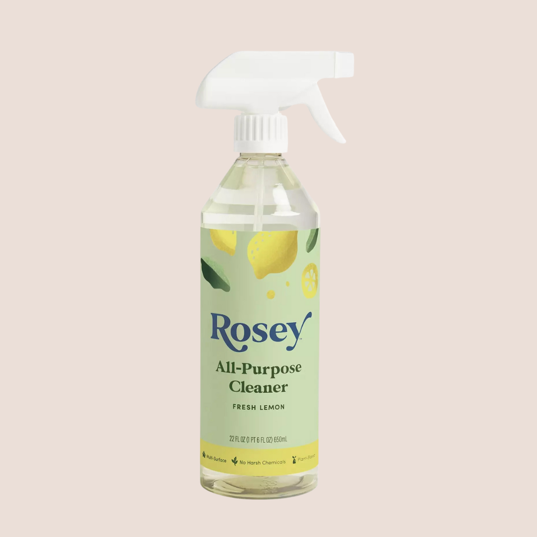 A bottle of Rosey All-Purpose Cleaner in fresh lemon scent with a white spray nozzle, against a plain light background.