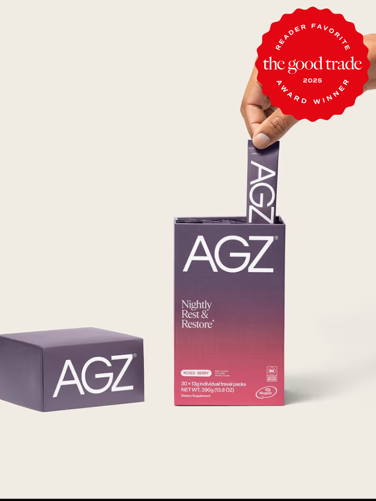 A hand pulls a packet from an AGZ Nightly Rest & Restore box; another AGZ box sits nearby. A red "The Good Trade 2025 Reader Favorite Award Winner" badge is at the top right.