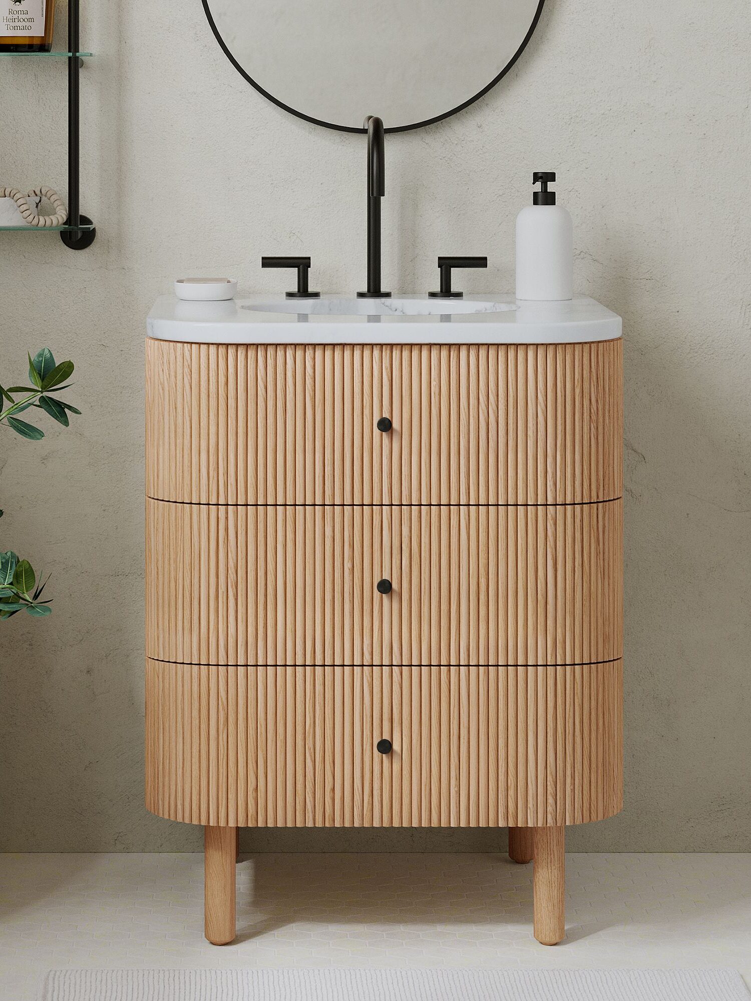 A modern bathroom vanity with ribbed wood drawers, a white countertop, black faucet, soap dispenser, and a round mirror above, set against a light textured wall.