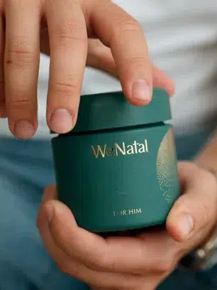 A person holds a green supplement container. Text explains nutrients may increase male fertility and live birth odds compared to not taking antioxidants.