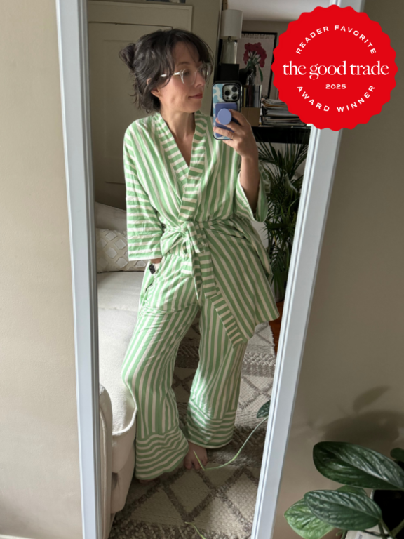 Person wearing green and white striped pajamas stands in front of a mirror taking a selfie. "The Good Trade 2025 Award Winner" badge is displayed in the upper right corner.