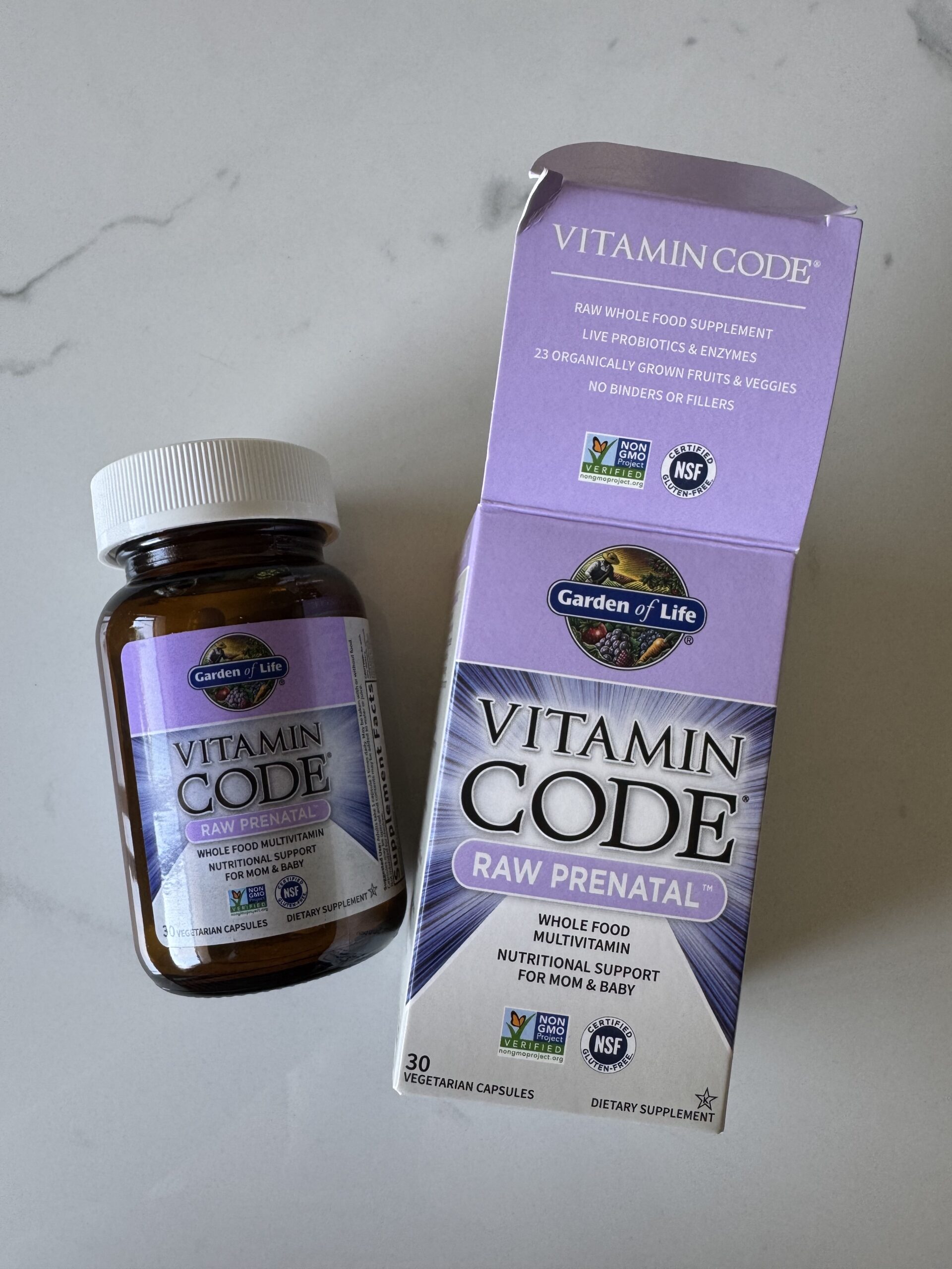 A bottle and box of Garden of Life Vitamin Code Raw Prenatal Multivitamin capsules, a trusted prenatal vitamin, on a white surface.