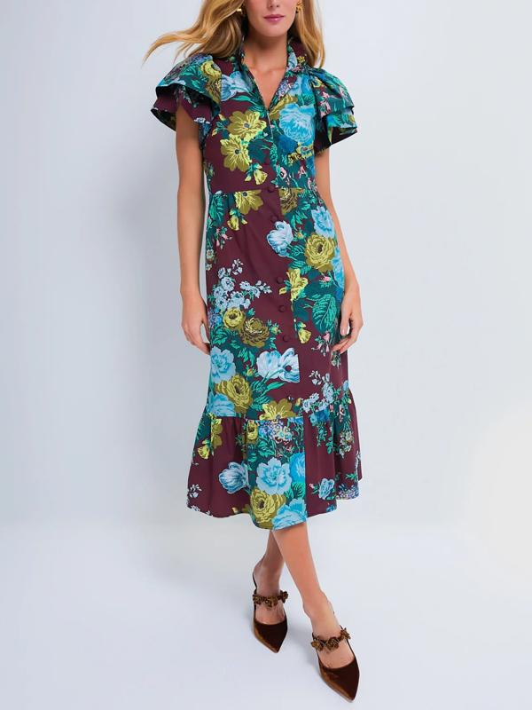 A woman wears a burgundy midi dress with a blue and green floral print, short ruffled sleeves, and brown pointed-toe flats against a plain light background.
