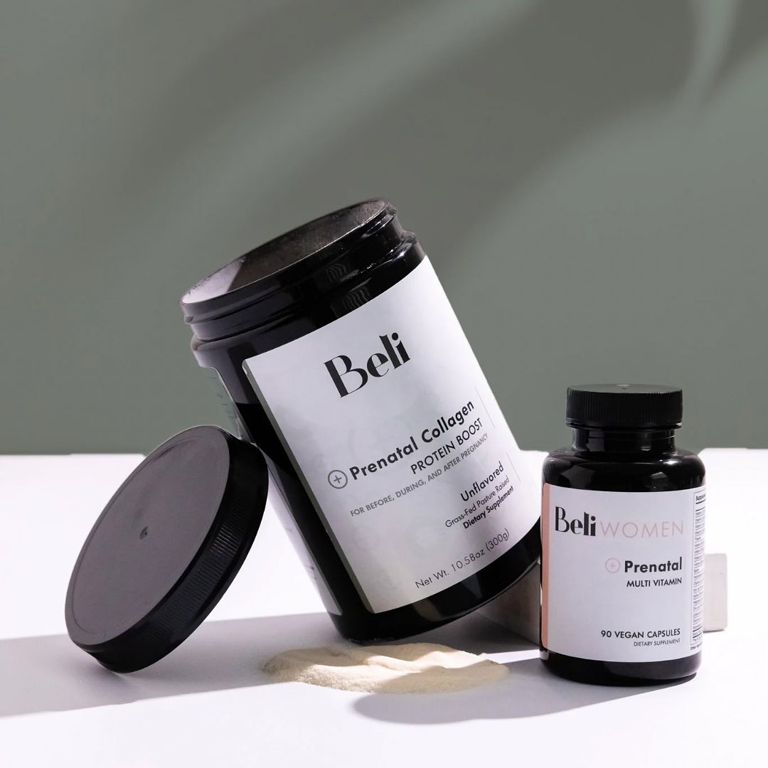 Two Beli branded supplement containers, one labeled "Prenatal Collagen Protein Boost" with powder spilled, and the other "Prenatal Multi Vitamin," are displayed on a light surface.