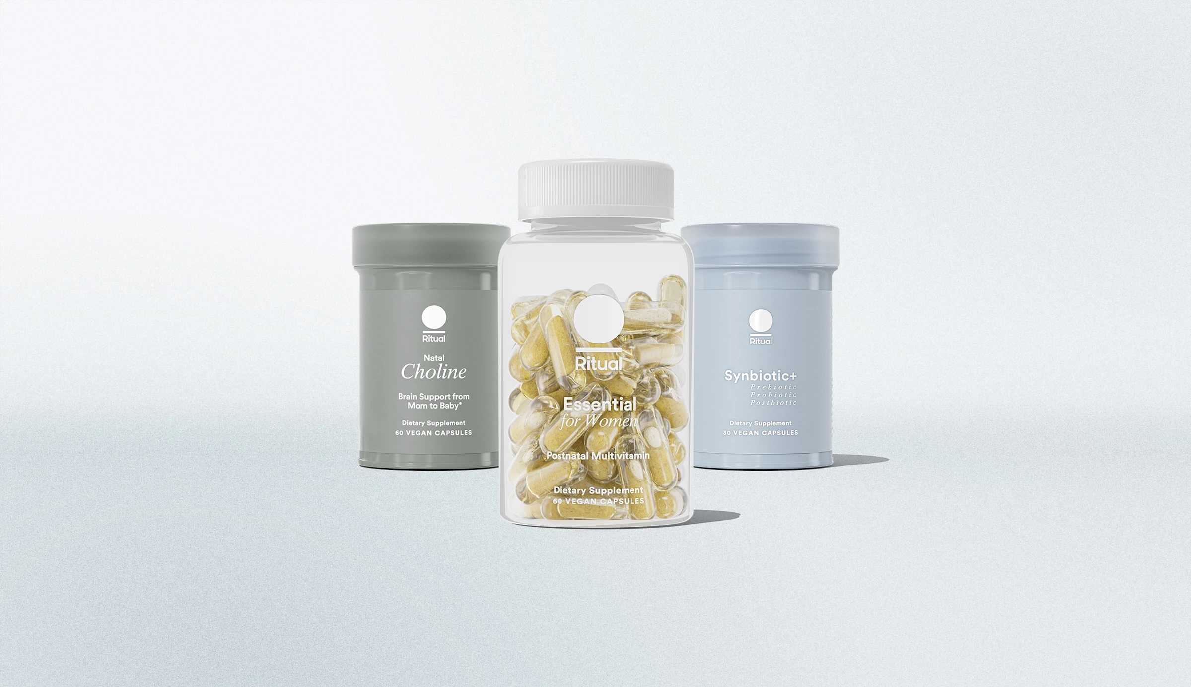 Three dietary supplement containers, with the center container labeled "Ritual Essential for Women," and two gray containers labeled "Choline" and "Synbiotic+," are displayed on a light background.