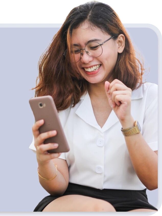 A young woman wearing glasses and a white shirt smiles and looks at her smartphone, with a heart icon displayed to the left of her.