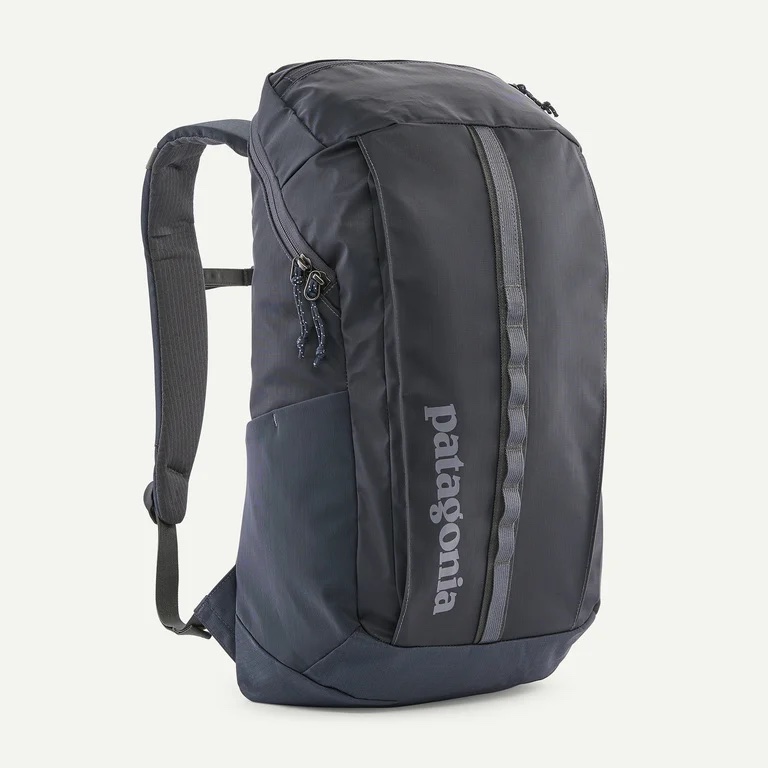 A dark gray Patagonia backpack with a front zipper, side pocket, and padded shoulder straps, displayed against a plain white background.
