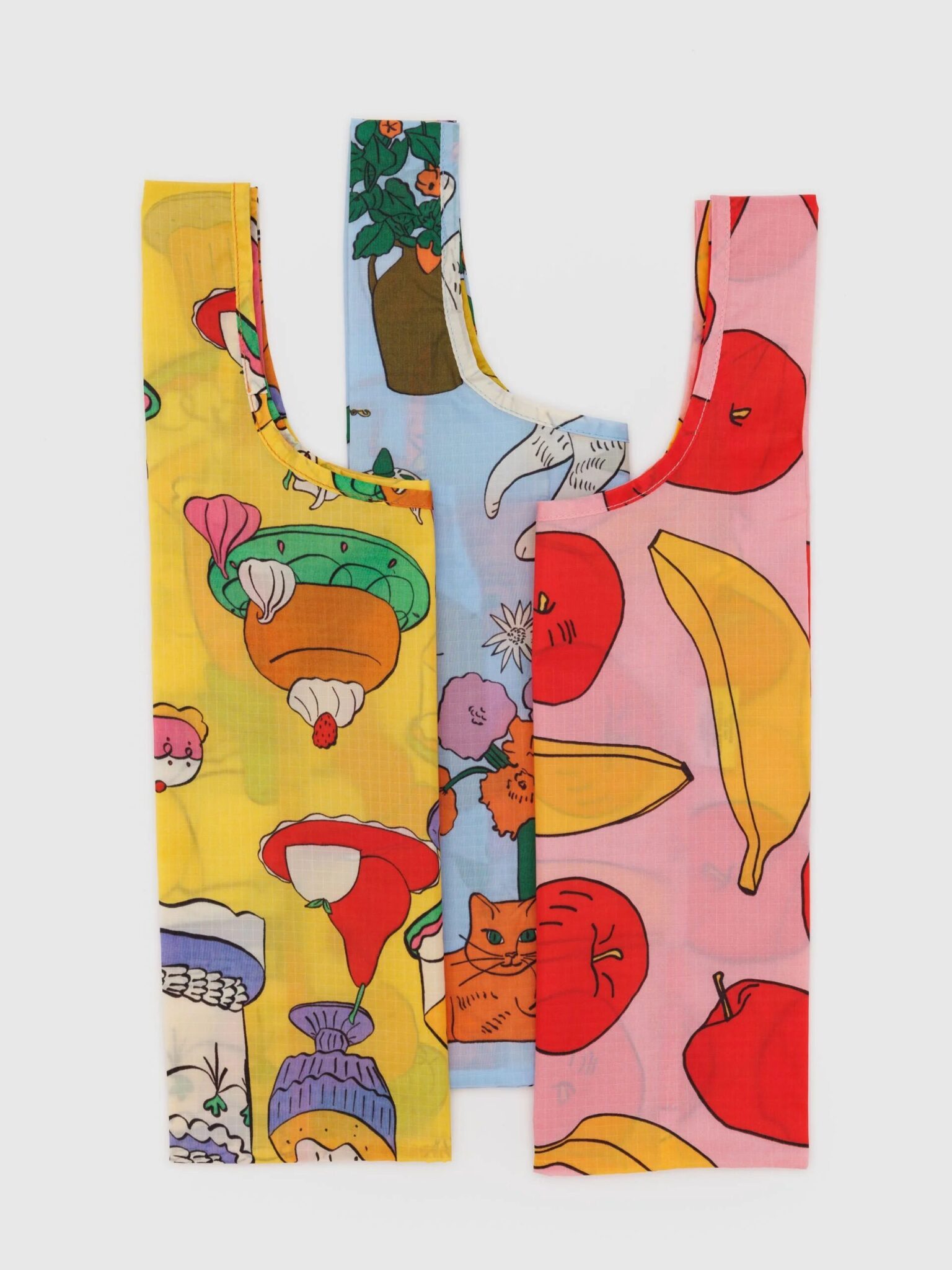 Three colorful reusable shopping bags with different playful patterns, including food, fruits, animals, and plants, displayed side by side on a plain white background.
