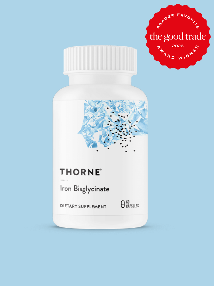A white bottle of Thorne Iron Bisglycinate dietary supplement with 60 capsules, set against a light blue background. A red "The Good Trade 2026 Reader Favorite Award Winner" badge is in the top right corner.