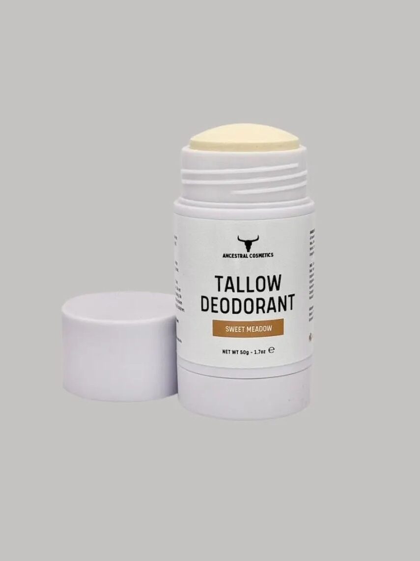 A white stick of tallow deodorant labeled "Sweet Meadow" with the cap removed, displayed against a plain gray background.
